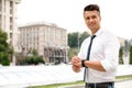 Portrait of handsome young man checking time on street. Space for text Royalty Free Stock Photo