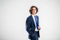 Portrait of a handsome young man in a dark blue business suit on a white background Royalty Free Stock Photo