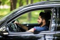 Portrait of a handsome young man driving a car on the road Royalty Free Stock Photo