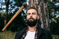 Portrait of handsome young man in forest. Working as a logger