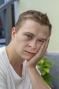 Handsome young man in the garden in thinking pose Royalty Free Stock Photo