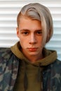 Portrait of a handsome young man with hair in a military jacket Royalty Free Stock Photo