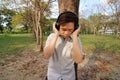 Portrait of handsome young man listening music with headphones in the park. Royalty Free Stock Photo