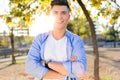 Handsome young man looking at camera in the park. Royalty Free Stock Photo