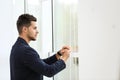 Portrait of handsome young man looking out window Royalty Free Stock Photo