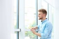 Portrait of handsome young man looking out window Royalty Free Stock Photo