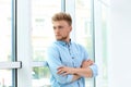 Portrait of handsome young man looking out window Royalty Free Stock Photo