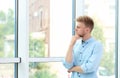 Portrait of handsome young man looking out window Royalty Free Stock Photo