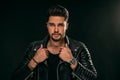 Portrait of a handsome young man with manly face. Male beauty. Fashionable brunet guy in black leather jacket looking at the Royalty Free Stock Photo