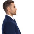 Portrait Of Handsome Young Man In Navy Blue Suit Looking To Side