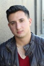 Portrait of a handsome young man with neutral expression at camera, on gray Royalty Free Stock Photo