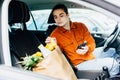 Portrait of handsome young man packing groceries into car , copy space Royalty Free Stock Photo