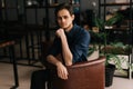 Portrait of handsome young man sitting in office at workplace, looking at camera. Royalty Free Stock Photo