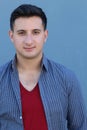 Portrait of a handsome young man smiling at camera, on blue Royalty Free Stock Photo