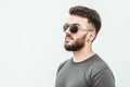 Portrait of a handsome young man standing against gray background. Youth culture. Barbershop Royalty Free Stock Photo