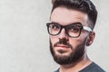 Portrait of a handsome young man standing against gray background. Youth culture. Barbershop Royalty Free Stock Photo