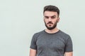 Portrait of a handsome young man standing against gray background. Youth culture. Barbershop Royalty Free Stock Photo