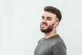 Portrait of a handsome young man standing against gray background. Youth culture. Barbershop Royalty Free Stock Photo