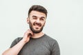 Portrait of a handsome young man standing against gray background. Youth culture. Barbershop Royalty Free Stock Photo