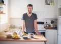 This is my diet for the day. Portrait of a handsome young man standing in front of meals which he has prepared in his Royalty Free Stock Photo