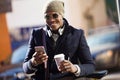 Handsome young man using his mobile phone in the street. Royalty Free Stock Photo