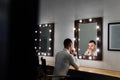 Portrait of handsome young man in white shirt looking into the mirror. Royalty Free Stock Photo