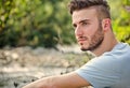 Portrait of handsome young man in white t-shirt in nature Royalty Free Stock Photo