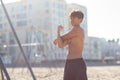 Portrait of a handsome young muscular man in swimwear on the muscle beach at Santa Monica next to fitness equipment Royalty Free Stock Photo