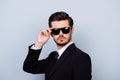 Portrait of handsome young serious man in black siut and glasses Royalty Free Stock Photo