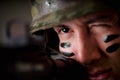 Portrait of handsome young soldier holding in his hands a rifle ready to shoot, winkle his eye to have more precision Royalty Free Stock Photo