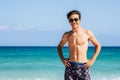 Portrait of handsome young teenager caucasian man smile and enjoy the summer holiday vacation at the beach with blue water and sky Royalty Free Stock Photo