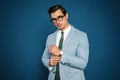 Portrait of handsome young  wearing glasses on blue background Royalty Free Stock Photo