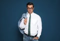 Portrait of handsome young  wearing glasses on blue background Royalty Free Stock Photo