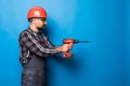 Portrait of bearded handyman with electric drill isolated on blue background Royalty Free Stock Photo