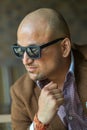 Portrait of a hansome indian businessman in sunglasses, serious and confident man