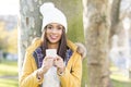 Portrait of happiness woman with hat holding phone, outdoor.