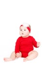Portrait of a happy adorable Infant child baby girl lin red sitting happy smiling on a white background Royalty Free Stock Photo