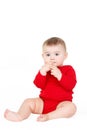 Portrait of a happy adorable Infant child baby girl lin red sitting happy smiling on a white background Royalty Free Stock Photo