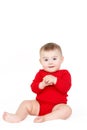 Portrait of a happy adorable Infant child baby girl lin red sitting happy smiling on a white background Royalty Free Stock Photo