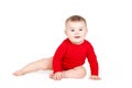 Portrait of a happy adorable Infant child baby girl lin red sitting happy smiling on a white background Royalty Free Stock Photo