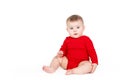 Portrait of a happy adorable Infant child baby girl lin red sitting happy smiling on a white background Royalty Free Stock Photo