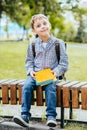 Portrait of happy adorable little kid boy holding different colorful books on first day to school or nursery. Back to Royalty Free Stock Photo