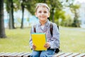 Portrait of happy adorable little kid boy holding different colorful books on first day to school or nursery. Back to Royalty Free Stock Photo