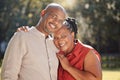 Portrait happy affectionate mature african american couple sharing an intimate moment outside at the park during summer Royalty Free Stock Photo