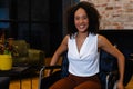 Portrait of happy african american casual businesswoman in wheelchair in office Royalty Free Stock Photo