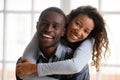 Portrait of happy african american couple embracing looking at c