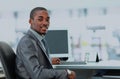 Portrait of a happy African American entrepreneur displaying computer laptop in office. Royalty Free Stock Photo