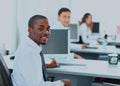 Portrait of a happy African American entrepreneur displaying computer laptop in office. Royalty Free Stock Photo