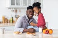 Portrait of happy african american family bonding at kitchen Royalty Free Stock Photo