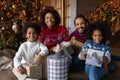 Portrait happy African American family celebrating Christmas, holding gift boxes Royalty Free Stock Photo